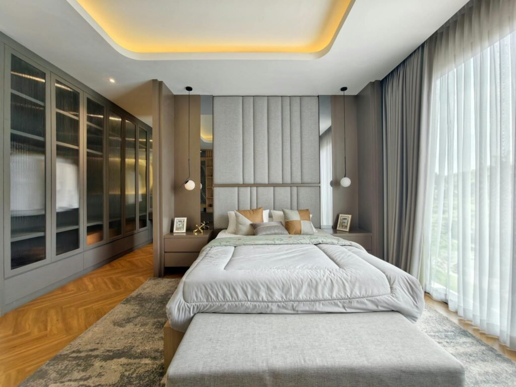 Luxurious modern bedroom design featuring large windows and sophisticated decor.