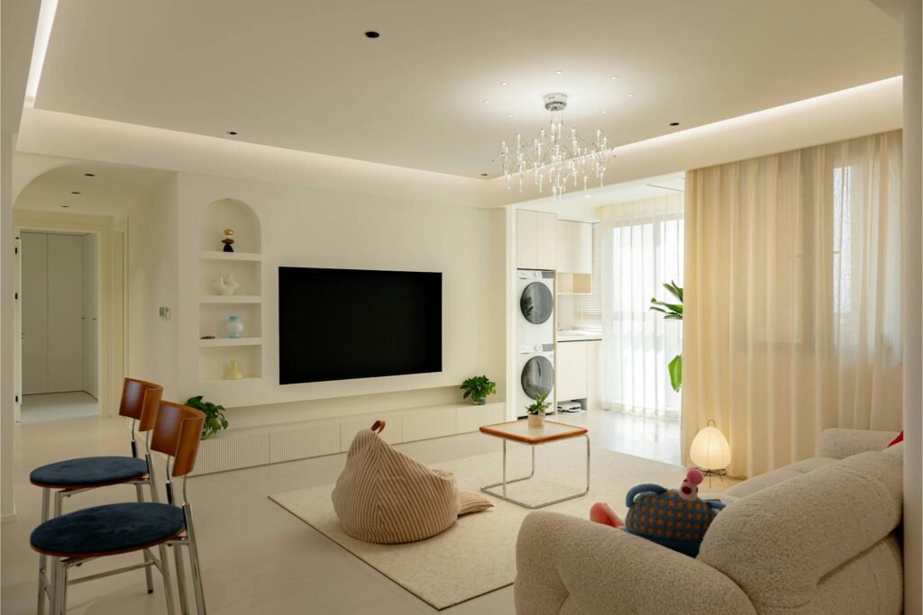 Spacious living room with modern decor, natural lighting, and minimalist design.